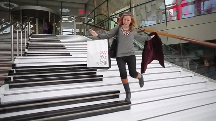 Excited lady walking down piano stairs