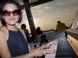 Pianovers Sailaway 2016, Julia Goh playing on the flybridge, with a sunset backdrop