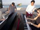 Pianovers Sailaway 2016, Chris Khoo, and Julia Goh playing the piano on the flybridge